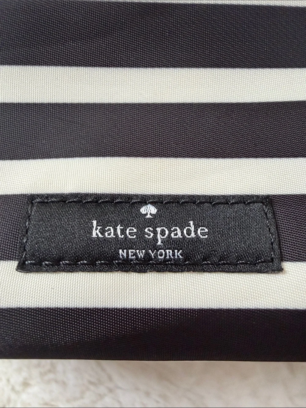 KATE SPADE,  black and white striped makeup pouch